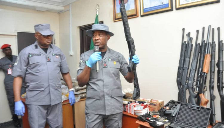 Comptroller Dera Nnadi shows one of guns intercepted by the command